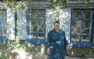 Ludmila Nikolaevna Ovchinnikova pictured with the 3 recovered windows.